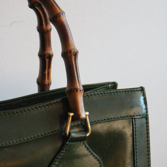 Stitching, golden hardware, and bamboo details of a medium green vintage Gucci Diana bag