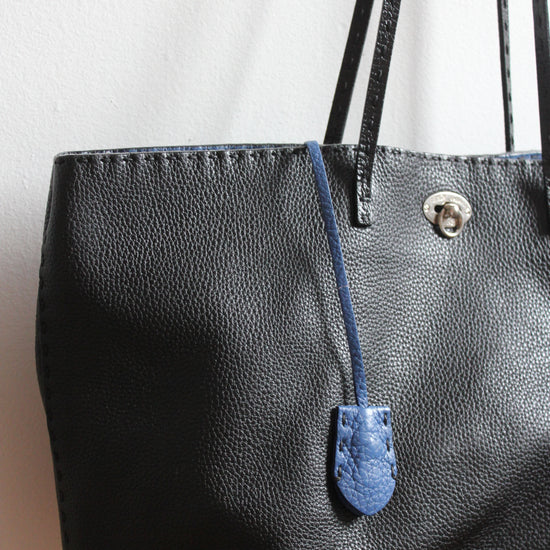 black Selleria black tote with blue leather lock key and chain holder