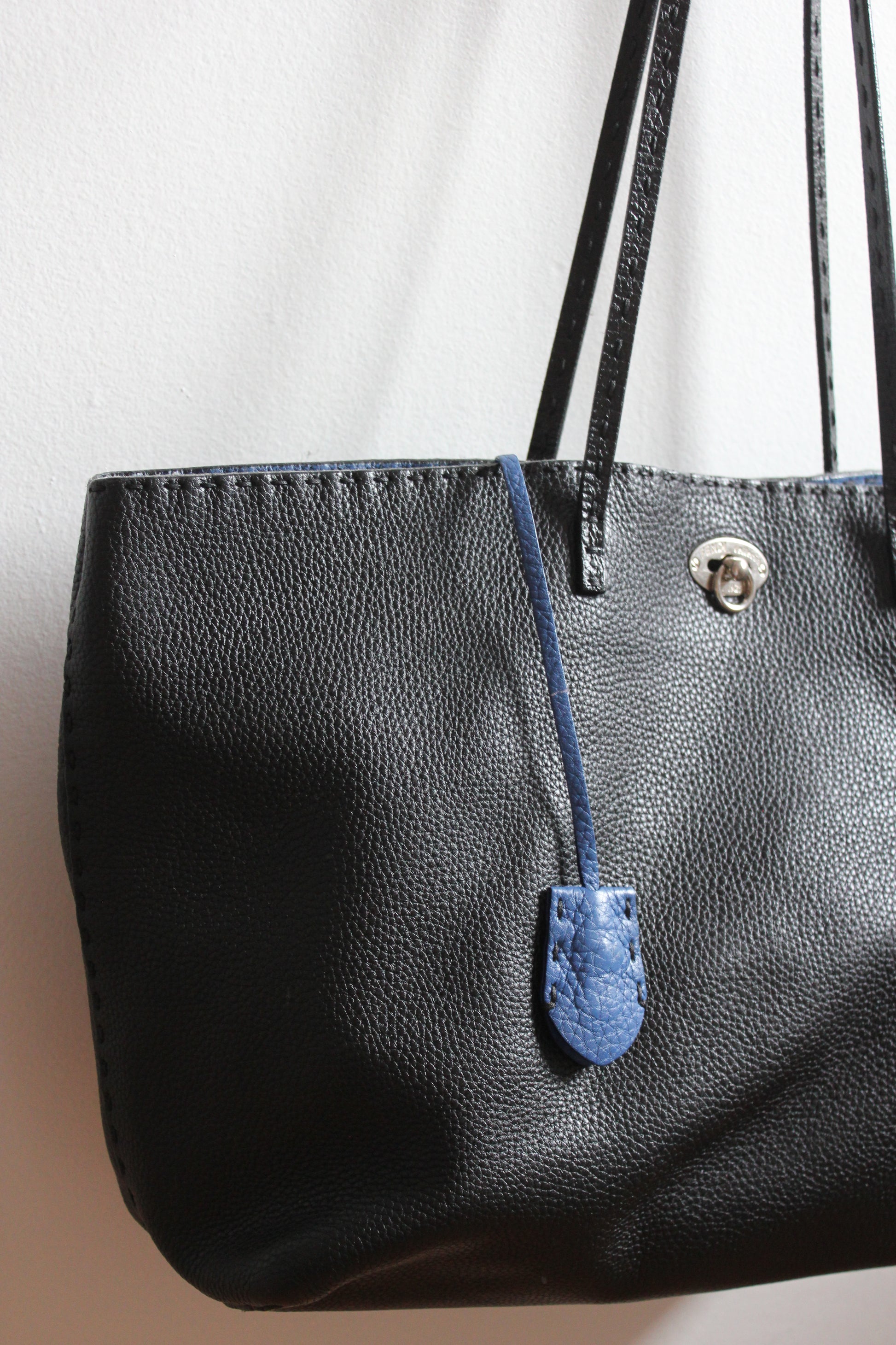 black Selleria black tote with blue leather lock key and chain holder