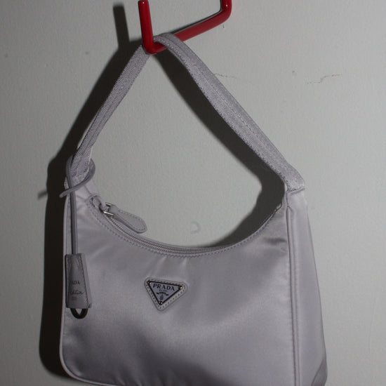 Side angle of Prada Tessuto Nylon bag re-edition in Lavender grey
