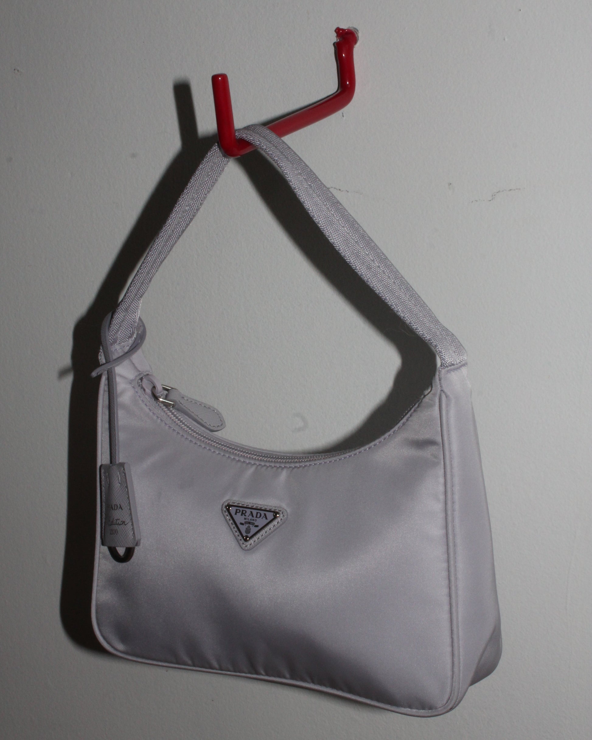 Side angle of Prada Tessuto Nylon bag re-edition in Lavender grey